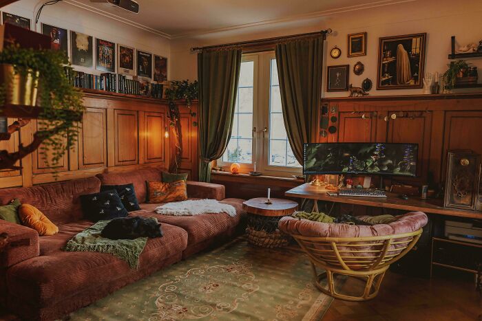 Cozy living room corner with vintage decor, green curtains, and a computer setup showcasing proud home decorating.