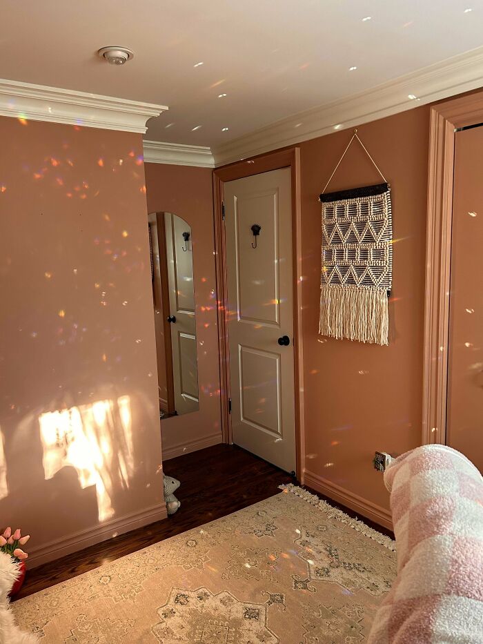 Cozy home corner with warm wall decor, soft lighting, and a patterned rug showcasing proud home decorating.