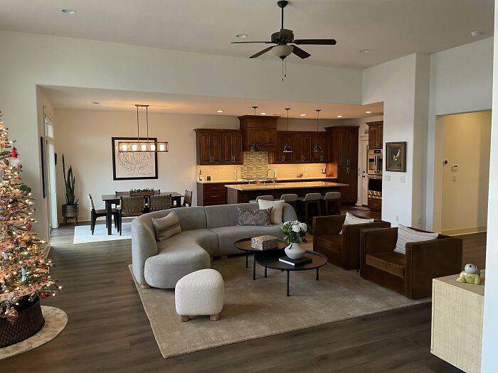 Cozy corner of a home with modern decor featuring a curved sofa and minimalist design, showcasing proud home decorating.