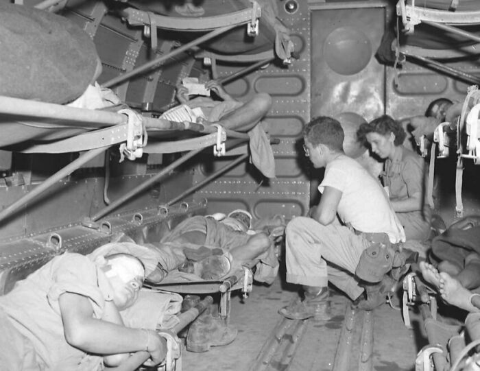 Rare WWII photo of wounded soldiers resting inside a military transport plane during World War II.