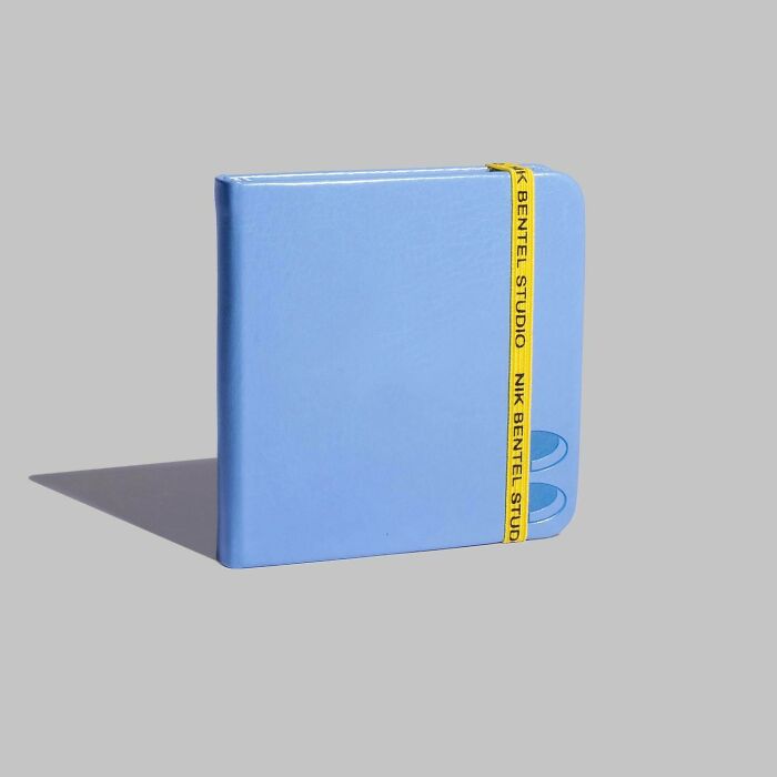 Blue wallet accessory by Nik Bentel, blending everyday objects with fashion in a minimalist design.