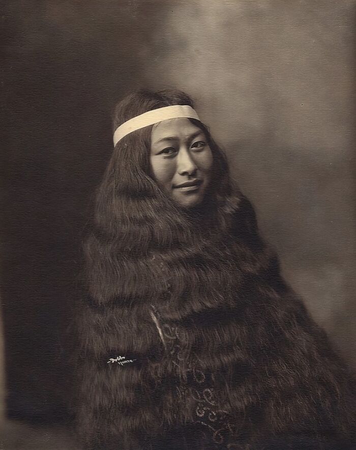 Historic photo of an Inuit woman with long hair wearing a traditional headband symbolizing the unbreakable spirit of the Inuit.