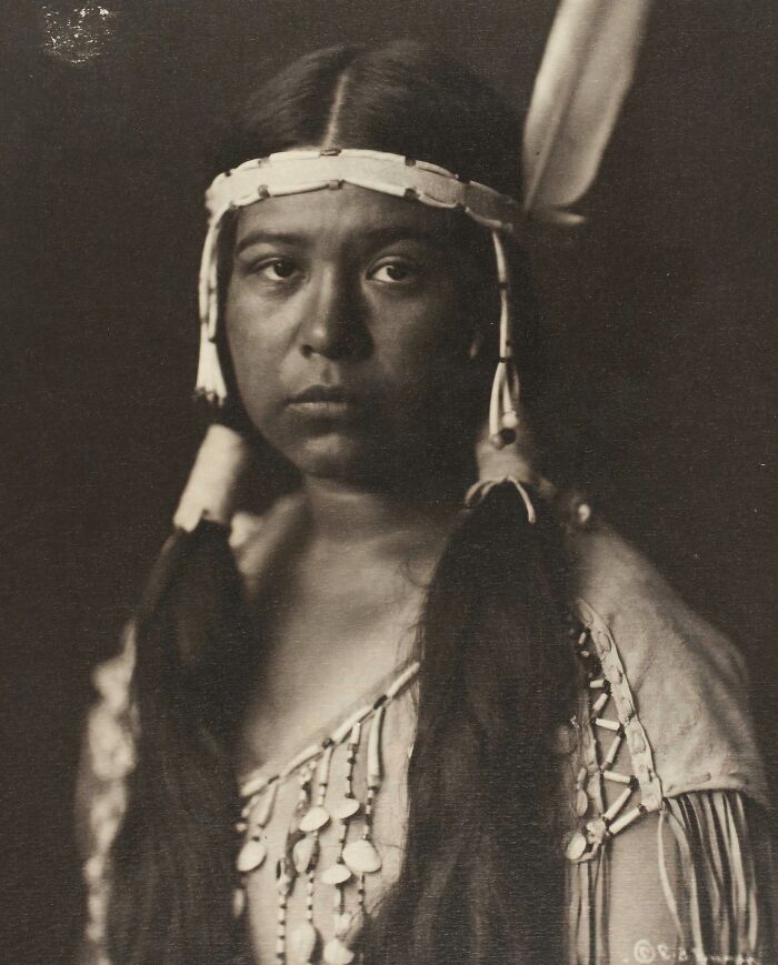 Portrait of a Native tribe member in traditional attire, showcasing the strength of Native tribes in the 1900s.