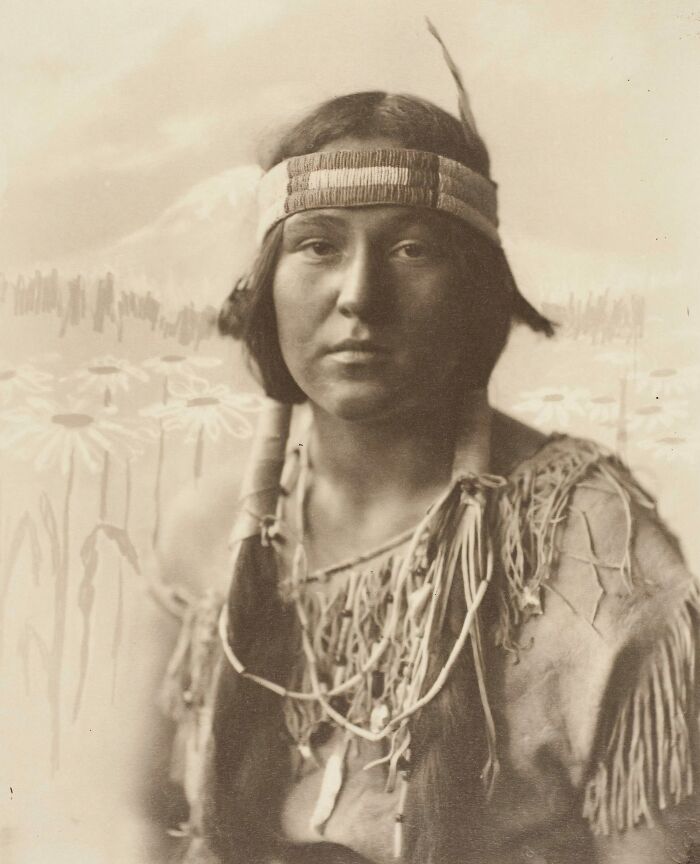 Portrait of a Native tribes member wearing traditional attire, captured to show the strength of Native tribes in the 1900s