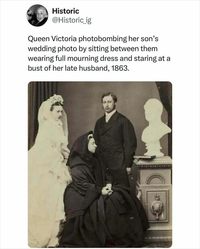 Historic photo of Queen Victoria in mourning dress sitting between her son and bride during wedding in 1863.