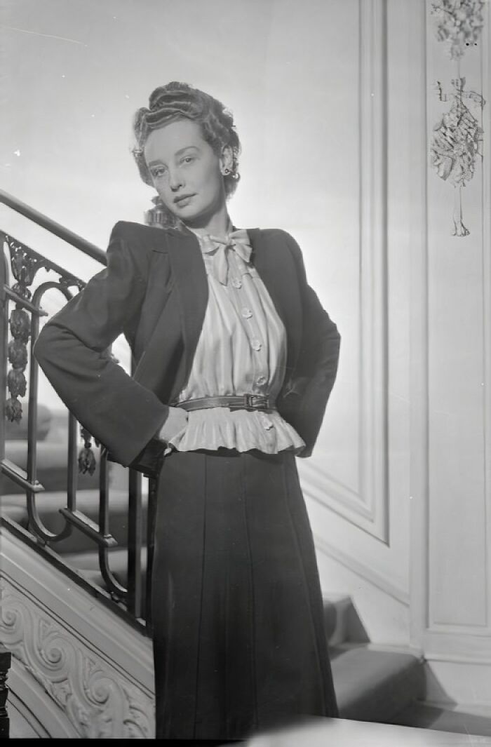British woman showcasing vintage style in a tailored jacket and skirt, reflecting WWII fashion and style during restrictions.