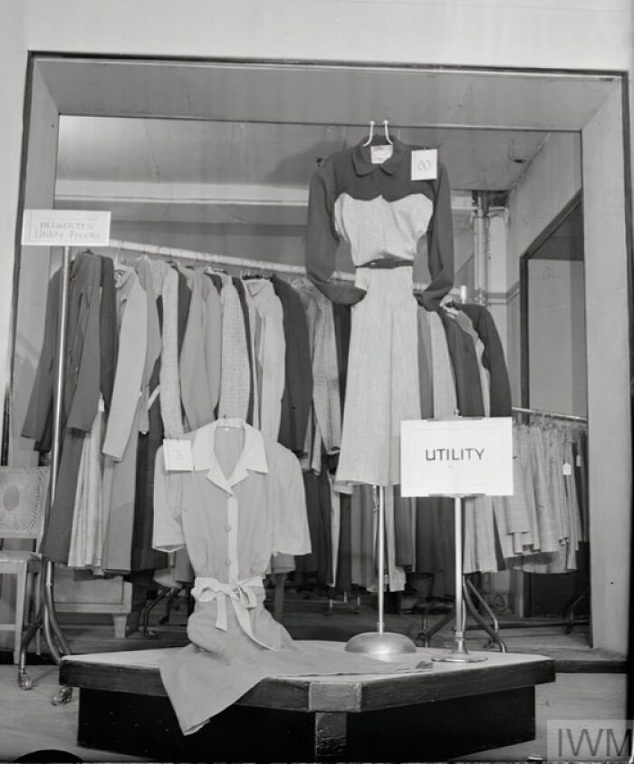 Display of British women's utility clothing during WWII restrictions, showcasing style and practicality amid fabric rationing.