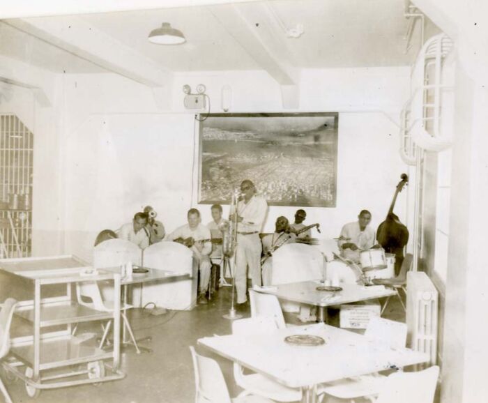 Inmate band playing instruments in a common room, offering rare glimpses into the harsh reality of life on Alcatraz.