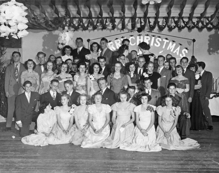 Group portrait of men and women in formal attire at a Christmas event showing rare glimpses of life on Alcatraz.