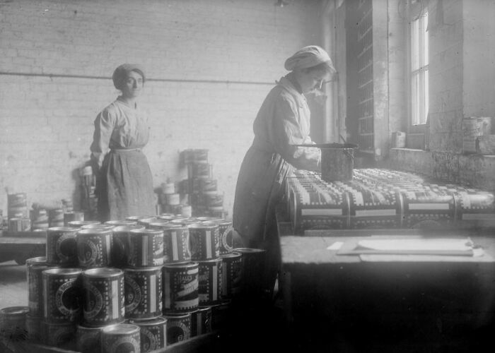 Women working in a factory during WWI, packaging supplies, showcasing how women changed everything in the war effort.