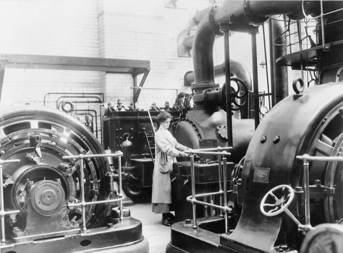 Woman operating large industrial machinery in a factory, illustrating how women changed everything during WWI.