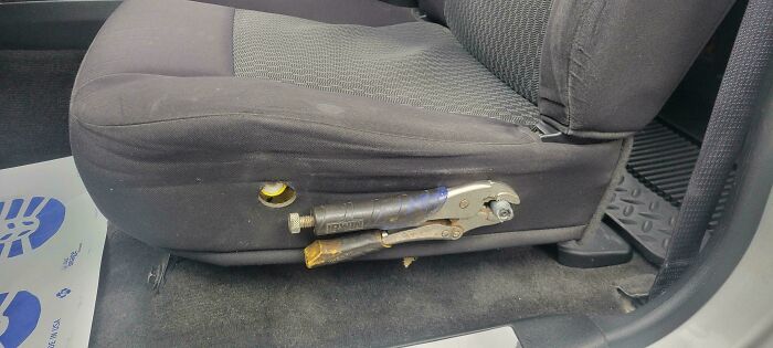 Car seat modified with a locking plier clamp as a redneck engineer's ingenious practical solution.