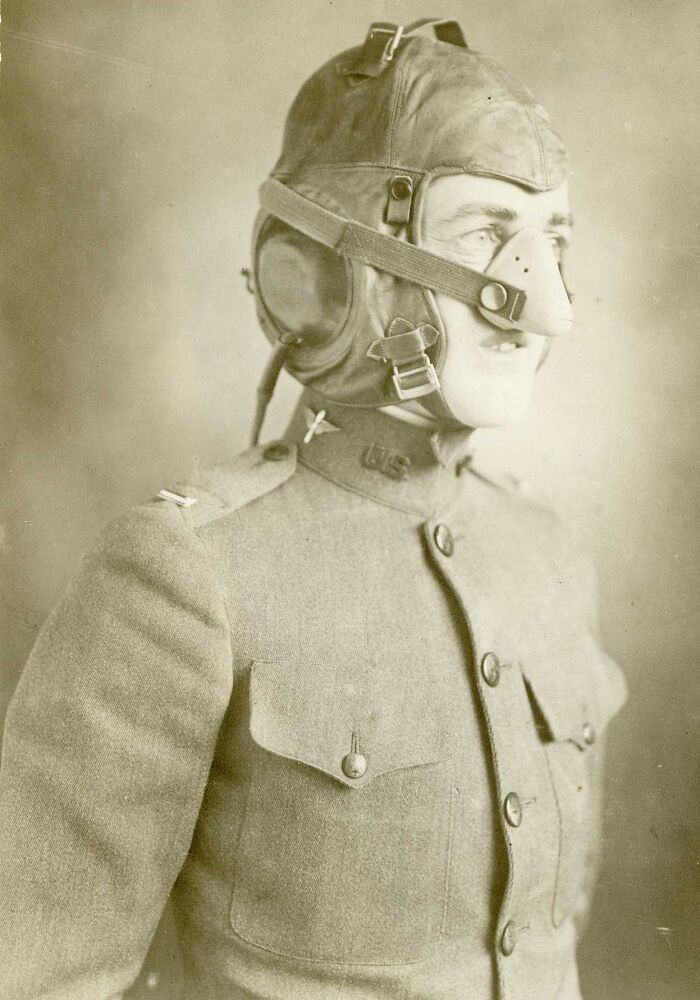 WWI soldier in uniform wearing a leather helmet and protective nose guard, revealing daily life beyond the trenches.