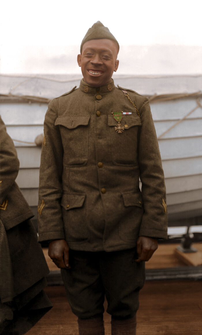 African American soldier in 1920s military uniform smiling, showcasing colorized photo of African American reality.