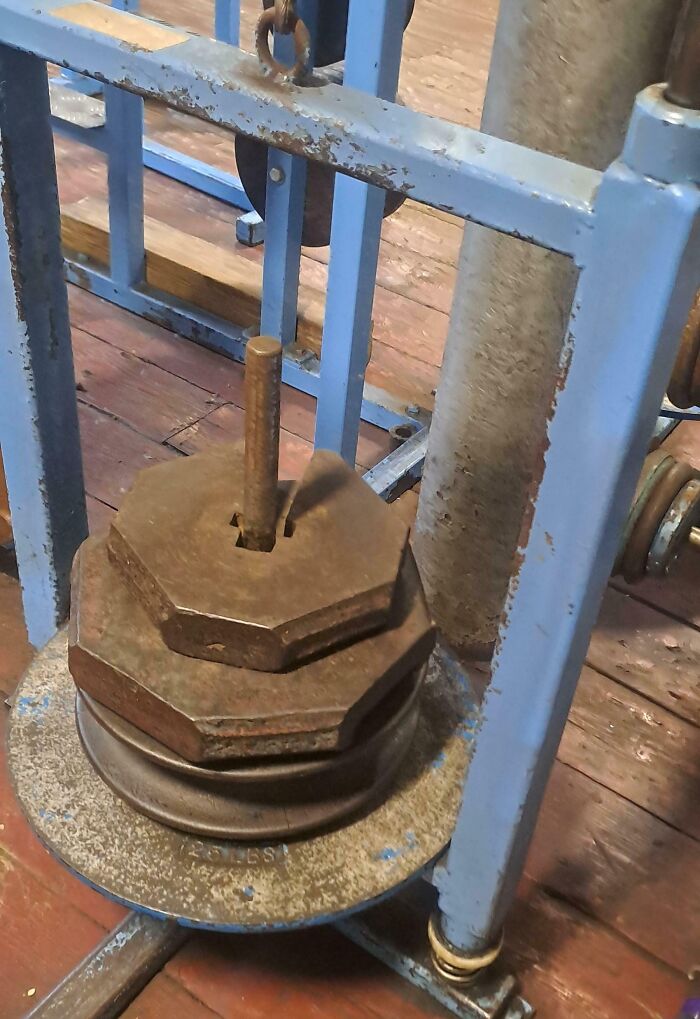 Rusty and mismatched weight plates stacked dangerously on gym equipment showing disregard for rules and etiquette.