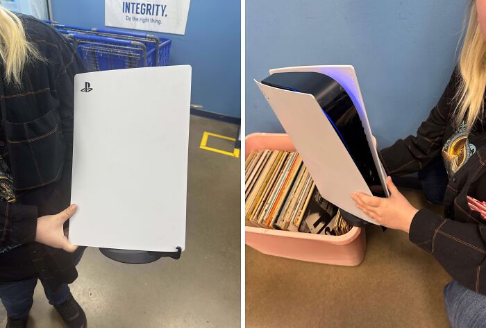 Person holding a PlayStation 5 console found among thrift store items with vinyl records in the background