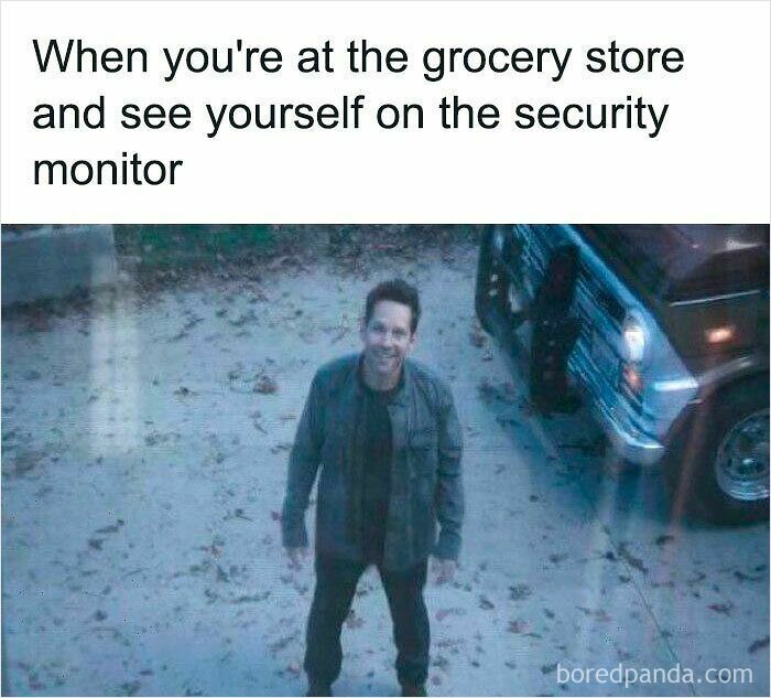 Man smiling outside next to a truck with text about seeing yourself on a grocery store security monitor meme.