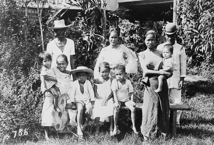 Filipino family in the 1890s outdoors, showcasing traditional clothing and lifestyle in historic Philippines.