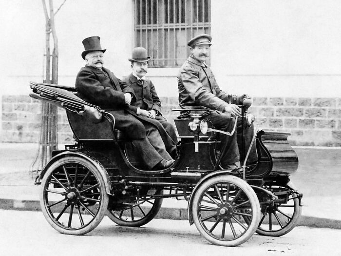 Early 1900s men riding in one of the first cars showing how wild the first cars really were.
