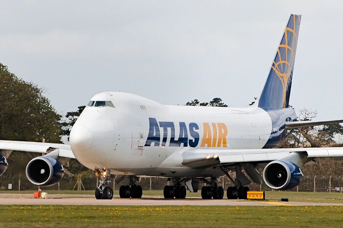 Atlas Air cargo plane on runway, showcasing record-breaking inventions that move at mind-blowing speeds in aviation technology.
