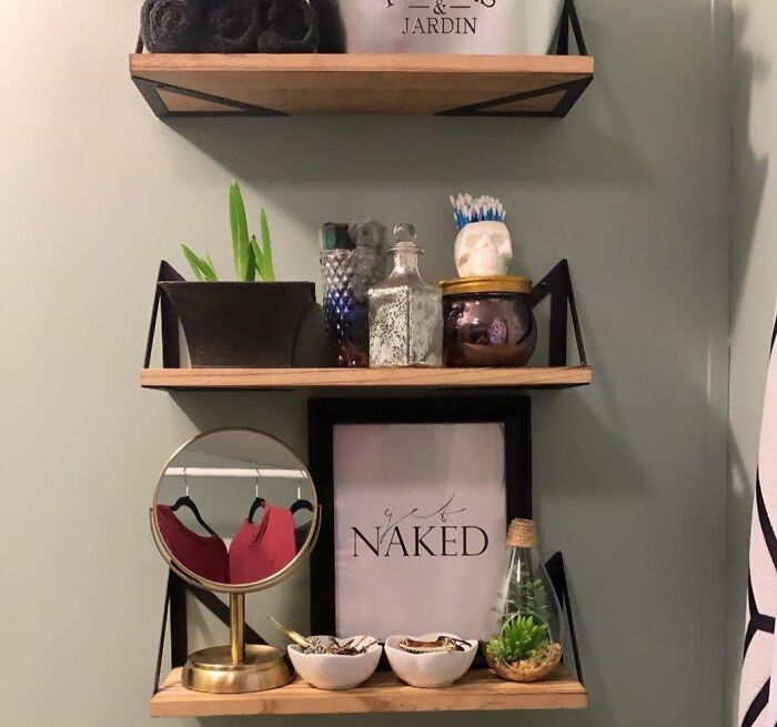 Bathroom shelves with plants, decor, and toiletries demonstrating low-lift, high-impact improvements for bathroom organization.