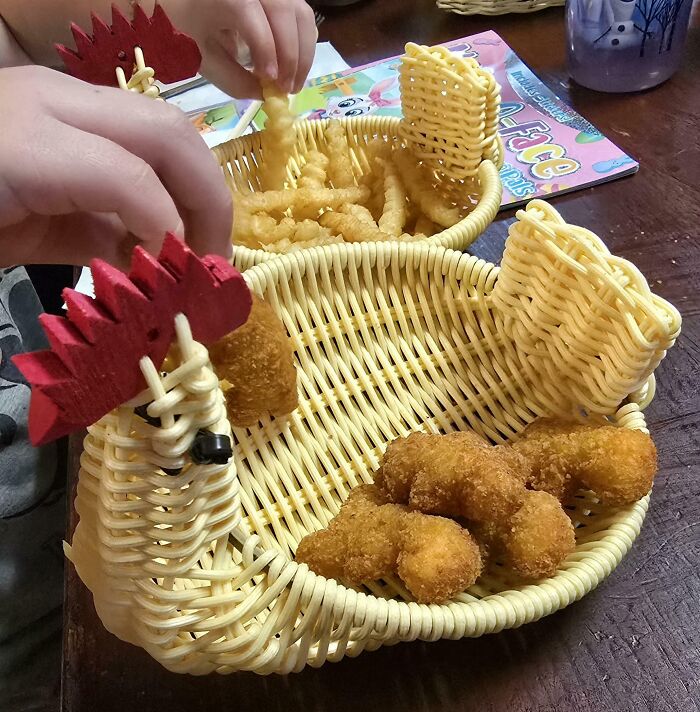 Creative basket shaped like a chicken holding chicken nuggets and fries, showcasing unique presentation at bars and restaurants.