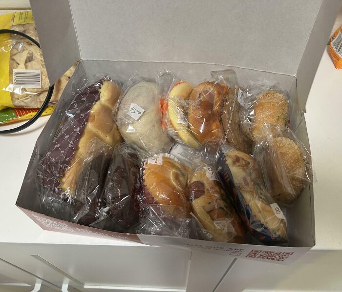 Assorted packaged baked goods in a box, ready to share with wholesome kind neighbors as a thoughtful gesture. Assorted packaged baked goods in a box, ready to share with wholesome kind neighbors as a thoughtful gesture.