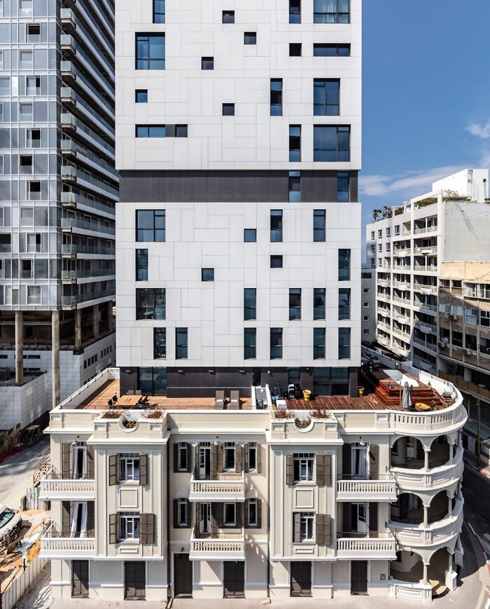 Old versus modern architecture combined in one building showing contrasting design styles in an urban setting.