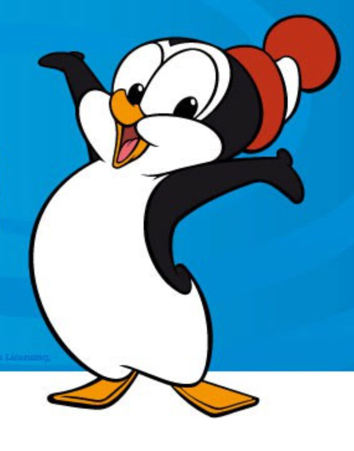 Smiling cartoon penguin wearing a red hat with arms raised, classic character from posts to make you feel old.