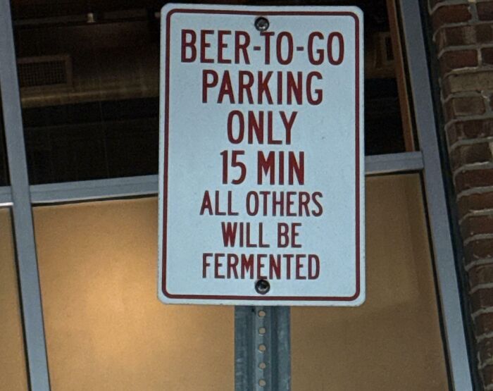 Funny parking sign about beer-to-go with a humorous message, among random notes and signs that lighten the mood.