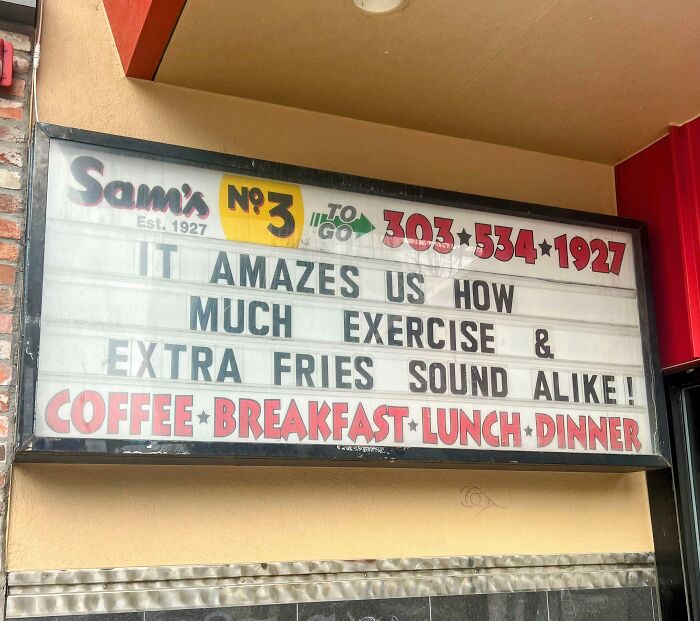 Humorous restaurant sign comparing exercise and extra fries, capturing hilariously random notes and messages about life.
