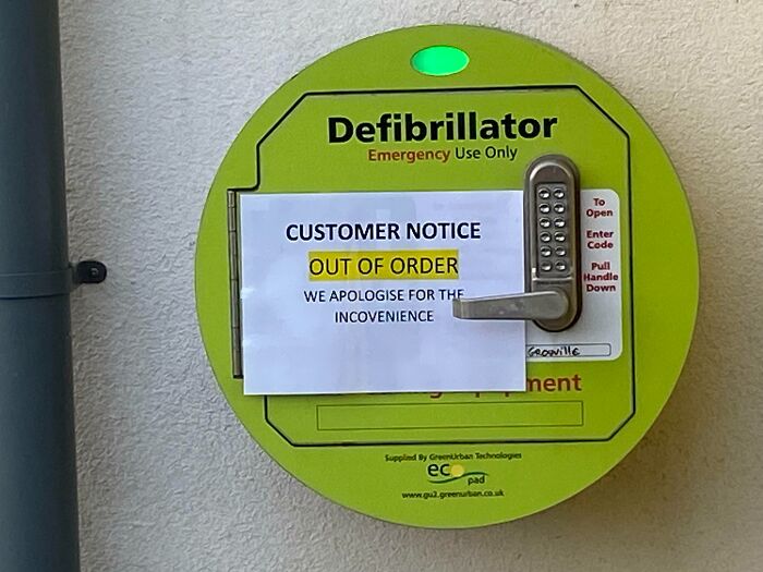 Defibrillator with a customer notice sign humorously labeled out of order, showing random notes that lighten the mood.