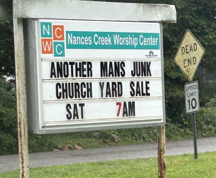 Church sign humor reads Another Mans Junk Church Yard Sale at 7 AM with road signs Dead End and Speed Limit 10 nearby.