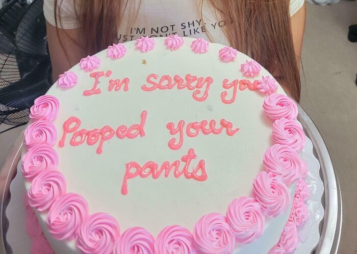 Cake with pink icing humorously apologizing for a silly accident, reflecting hilarious random notes that lighten life's mood.