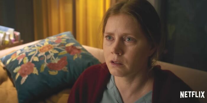 Woman with worried expression sitting on couch, representing Netflix movies that turned out to be total letdowns. Woman with worried expression sitting on couch, representing Netflix movies that turned out to be total letdowns.