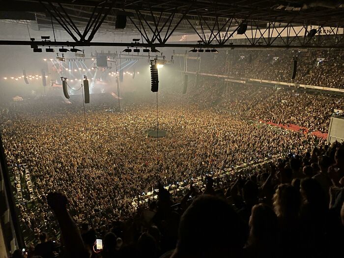 Large crowd at a Danish concert venue with stage lights and sound equipment, showcasing Denmark’s vibrant culture and events.
