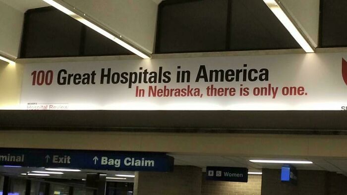 Hospital advertising placement fail showing a sign claiming one great hospital in Nebraska among 100 in America.