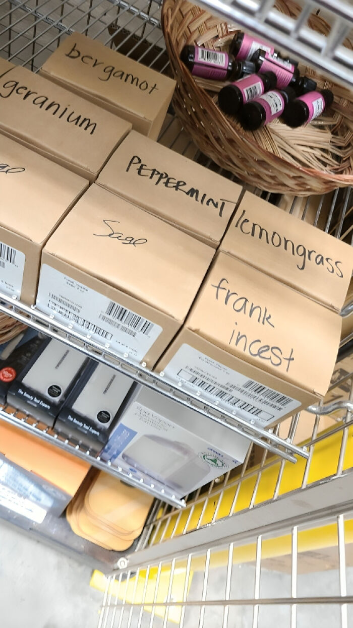 Boxes of herbs and oils on a store shelf with a typo spelled as frank incest instead of frankincense.