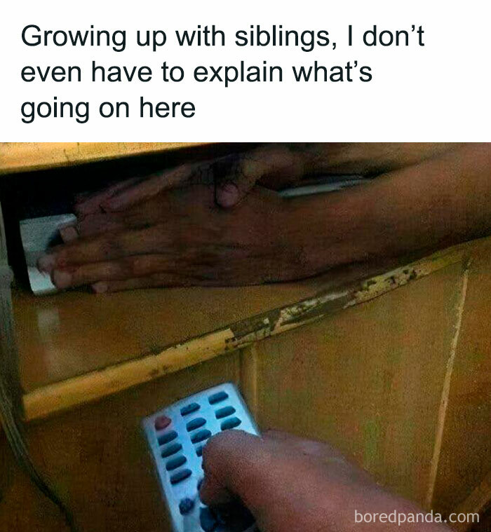 Hands hiding a TV remote under a desk with caption about growing up with siblings, highlighting '90s nostalgia club' memories.