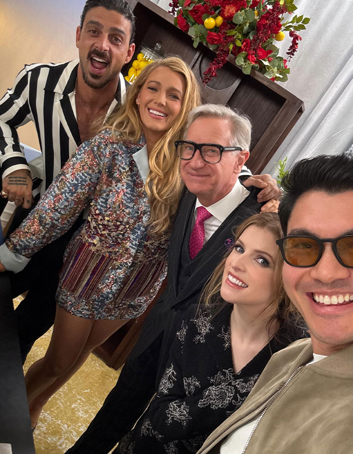 Blake Lively with cast and director smiling on set of new rom-com, capturing a joyful group moment indoors. Blake Lively with cast and director smiling on set of new rom-com, capturing a joyful group moment indoors.