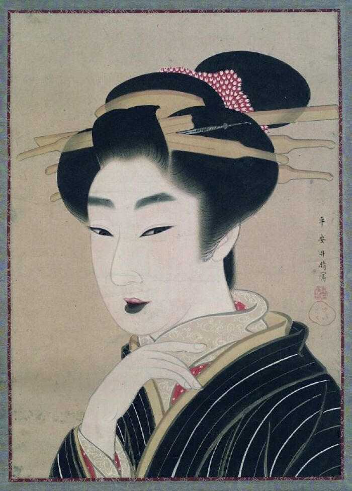 Traditional Japanese portrait showcasing historical beauty standards through hairstyle and makeup in classic attire.