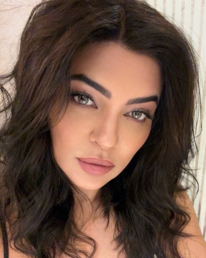 Close-up portrait of a Miss Universe winner with dark hair and striking eyes captured in a stunning photo.