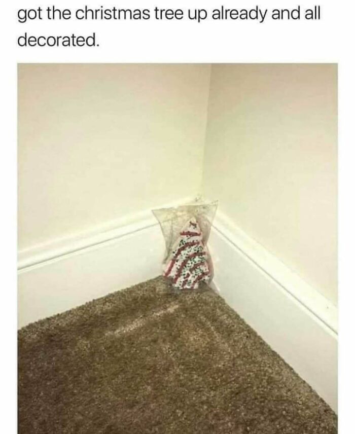 Small decorative Christmas tree placed in a corner on carpeted floor, showcasing ingenious crafty ideas from an IG account.