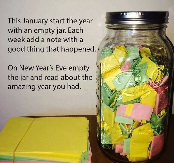 Jar filled with colorful folded notes beside a stack of paper, showcasing one of the best crafty ideas from an IG account.