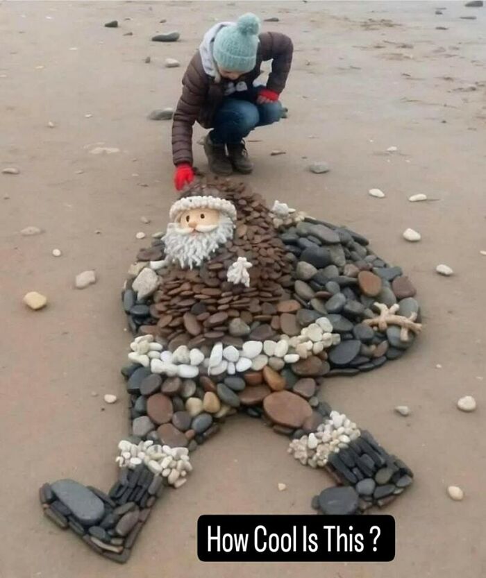 Child arranging stones on a beach to create a crafty Santa figure, showcasing ingenious crafty ideas from an IG account.