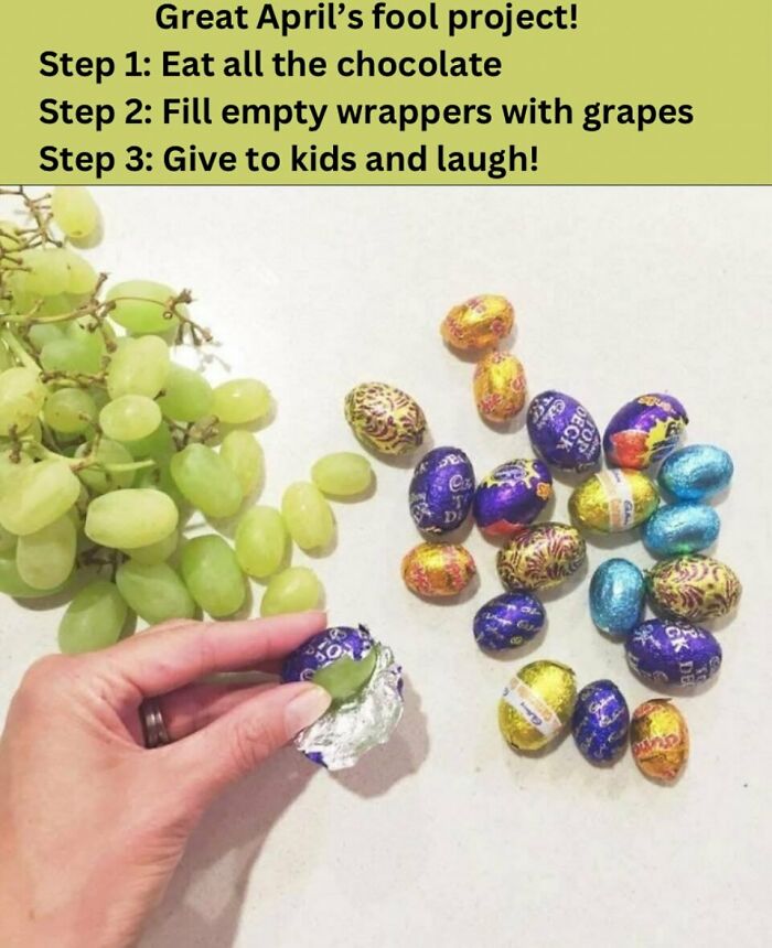 Hand placing a grape inside an empty chocolate wrapper, showcasing a crafty idea from an ingenious IG account.