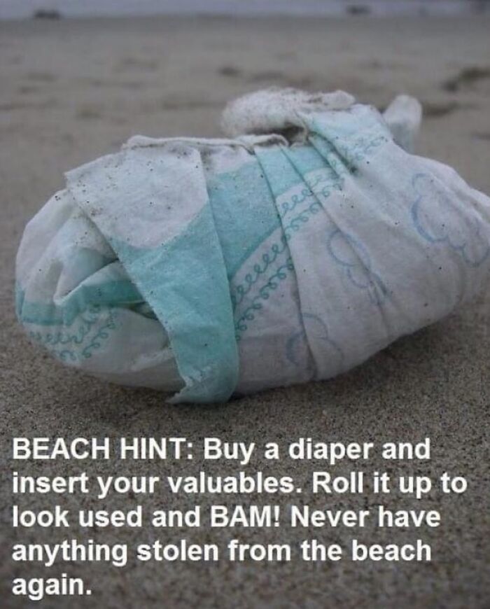 Ingenious crafty idea showing a rolled-up diaper on sand used to safely hide valuables at the beach.