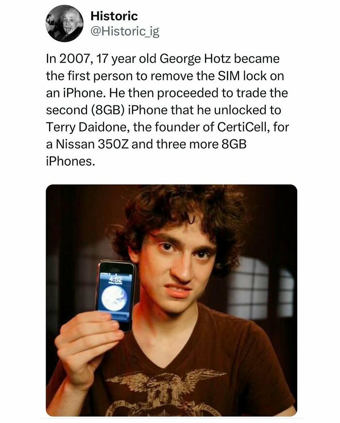 Young George Hotz holding an unlocked iPhone, a historic moment in tech innovation and unlocking devices.