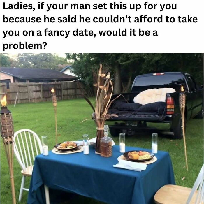 Outdoor creative date setup with truck bed seating, table with food, tiki torches, showcasing ingenious crafty ideas.