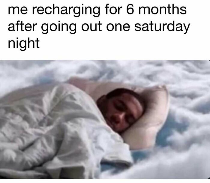 Person lying peacefully in bed covered with a white blanket, symbolizing recharging and good vibes after a busy night.